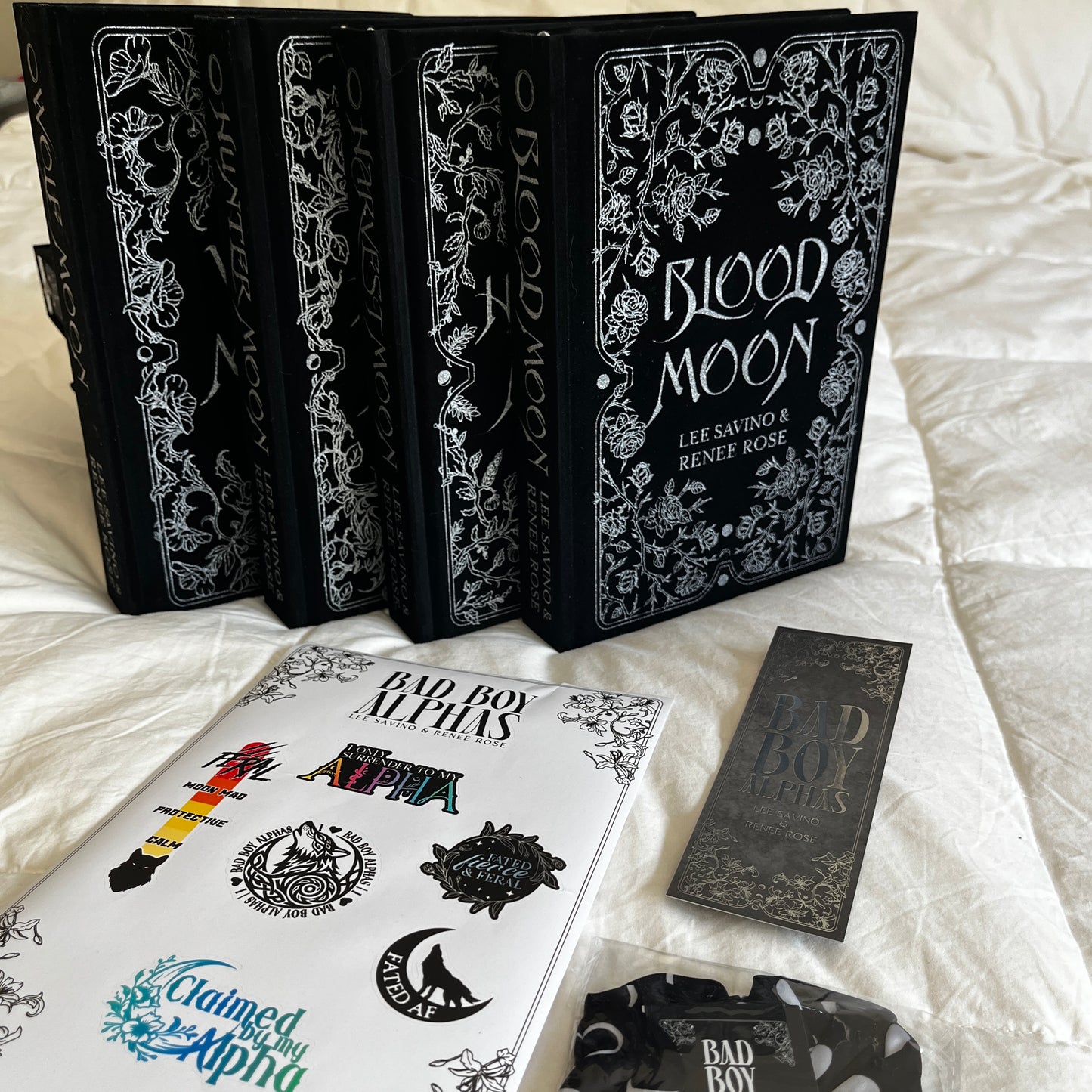 Collection of books with decorative covers on a white surface