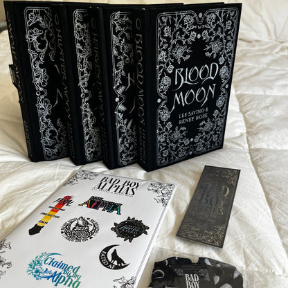 Collection of books with decorative covers on a white surface