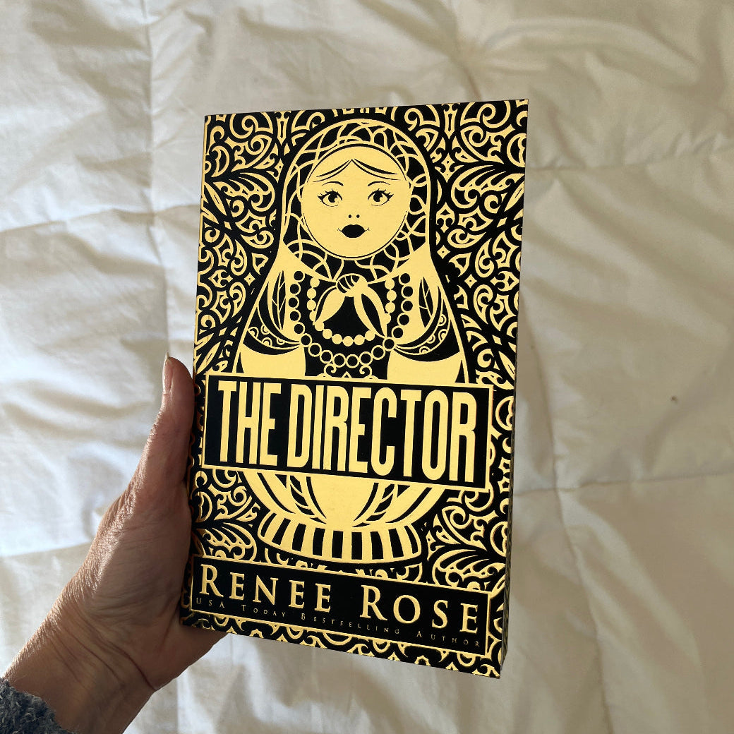 Book titled 'The Director' by Renee Rose held against a white background