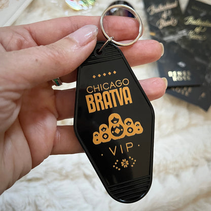 Keychain with 'Chicago Bratva VIP' text held by a hand on a light background