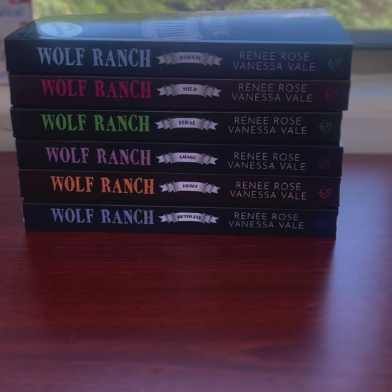 Sped up video. It starts by showing all the books from the Wolf Ranch Series in a stack. A white woman -- Renee Rose-- grabs the top book which has an "Autographed Copy" sticker on it and opens it to show that is has been signed by Renee Rose and Vanessa Vale. 