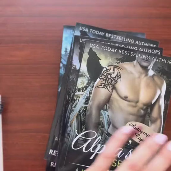 Video of a white woman -- Renee Rose-- writing notes and signing several of the paperbacks from the Bad Boy Alphas Series. 